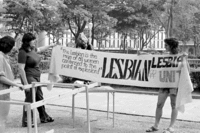 Sharon Younginger and Barbara Bjanes hold lesbian banner